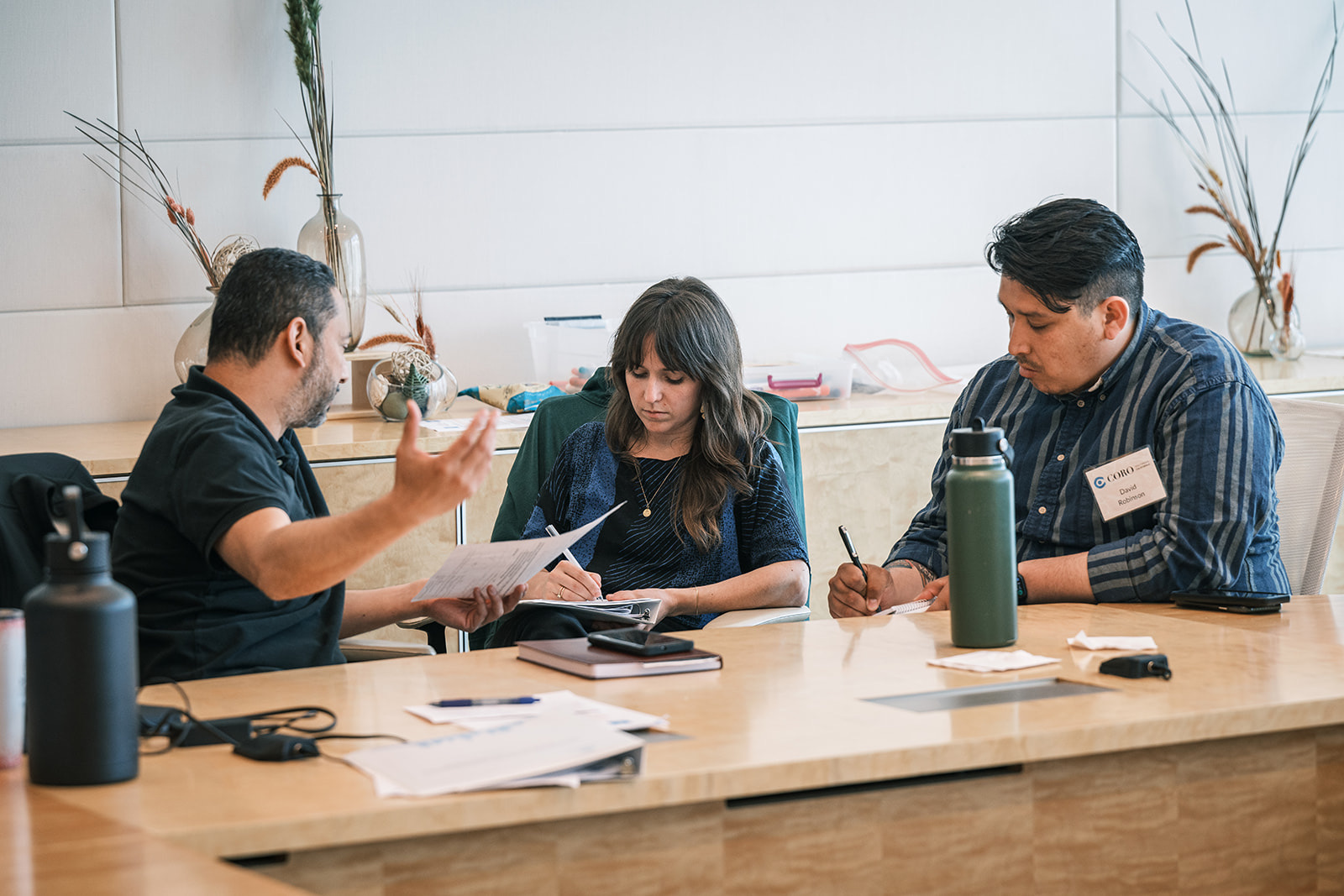 Coro participants collaborating around a table