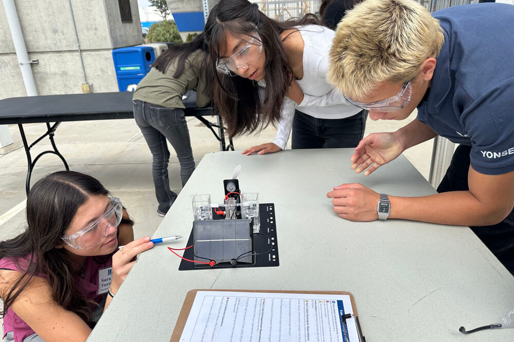 Youth Climate Fellows work with hydrogen fuel cells kits to understand how hydrogen can be harnessed as a renewable energy source using solar power.