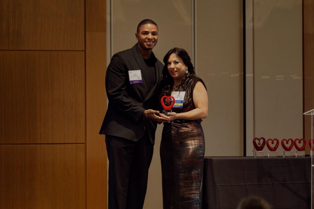 Warren Northern receiving the 2025 Outstanding Emerging Professional award at the National Philanthropy Day Awards, presented by then Chapter Board President Andrea Salazar.