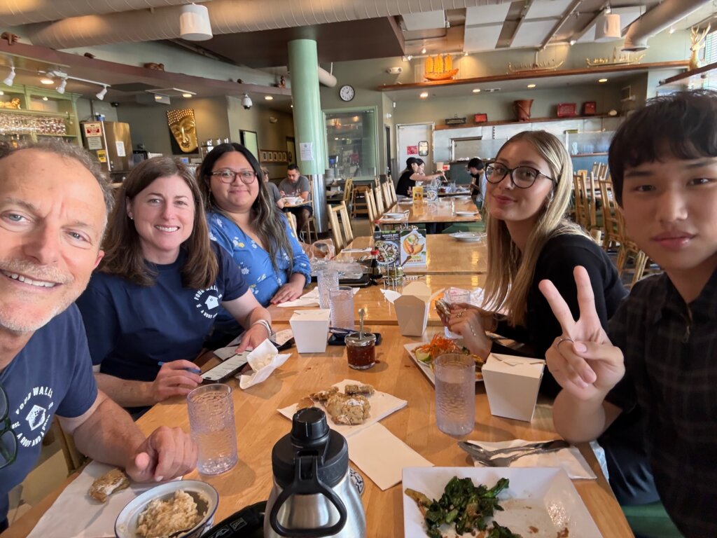 Youth Fellows Journey Shapiro and Joshua Kim eat lunch with their placement supervisors.