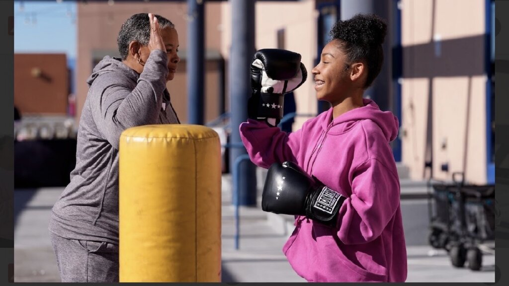 Dawna with a member of the East Oakland Boxing Association community.
