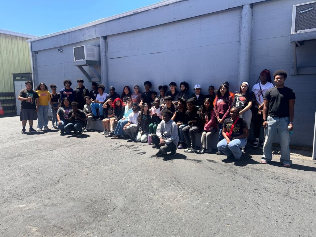 Rosie and Dhairya, Coro’s Exploring Leadership Fellows, with members of the East Oakland Boxing Association community.
