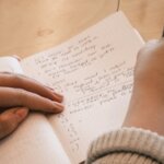 A participant taking handwritten notes during a learning session.